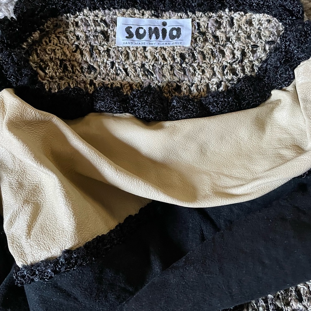 Woman’s hand knit multicolored black/beige sweater